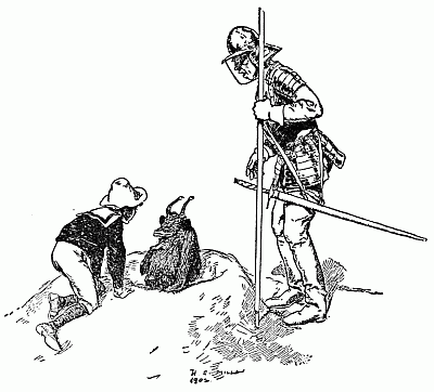 Robert kneels beside the Psammead as an armored soldier stands watch with a spear.