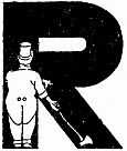 A man in a cap stands beside a large decorative letter R.