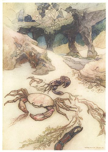 Two crabs rest on the sand near a rocky sea cave entrance.