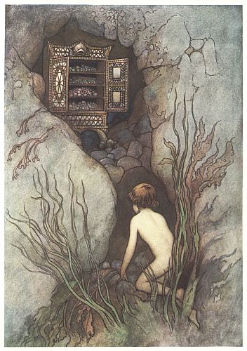 Tom kneels before an ornate cabinet tucked into a rocky underwater nook.