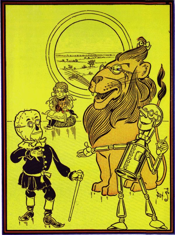 The Scarecrow touches his chin as the bespectacled Lion, Tin Woodman, and Dorothy look on.